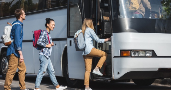 passengers happily boarding a bus